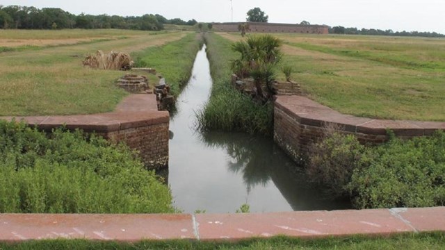 Feeder canal delivers water to the moat and ditches to control water flow