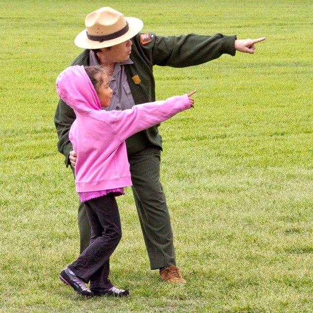 Ranger and little girl pointing 