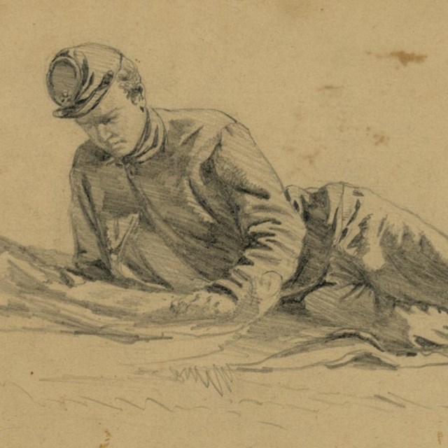 Sketch of a Civil War soldier laying and reading a letter from home.