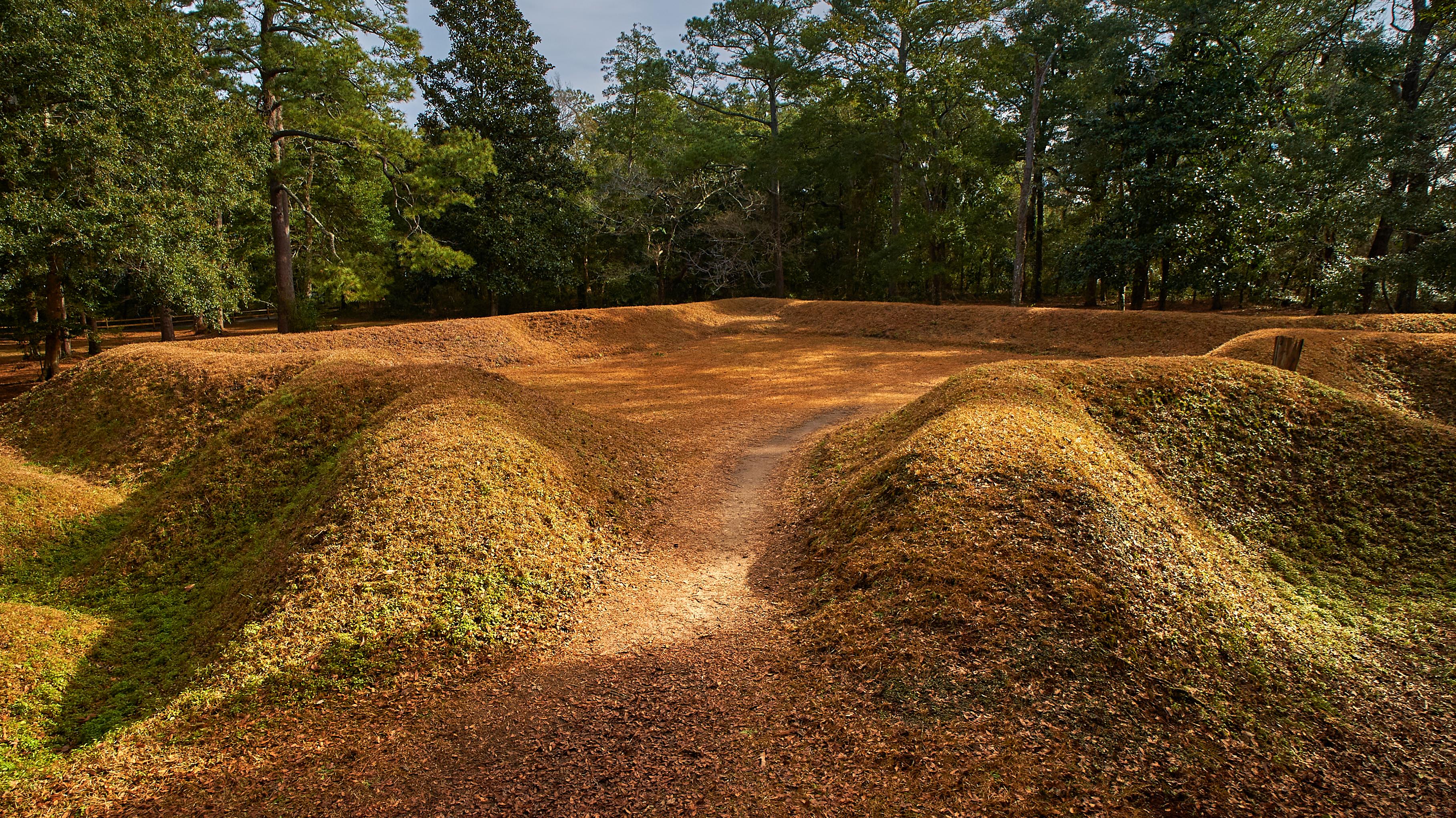 Reconstructed earthen fort covered in grass