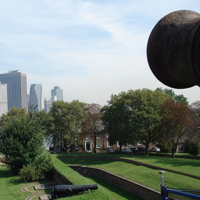 a canon on right foreground overlooks manhattan
