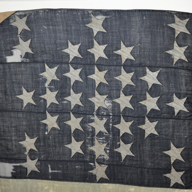 A blue field with 33 white stars.  Part of the original Fort Sumter 