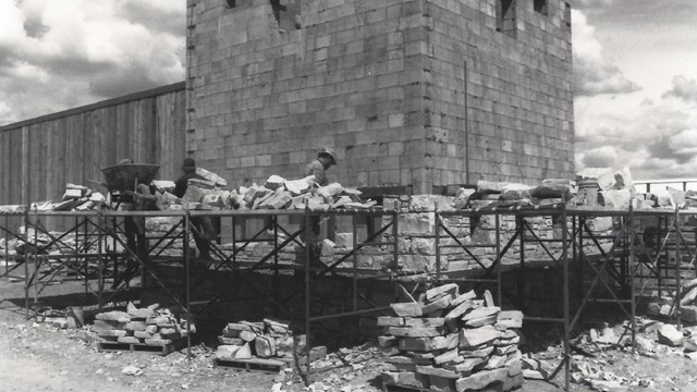 Stone masons laying the stone veneer on one of the bastions.