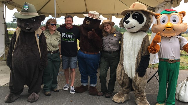A group of people with mascots including Smokey Bear.