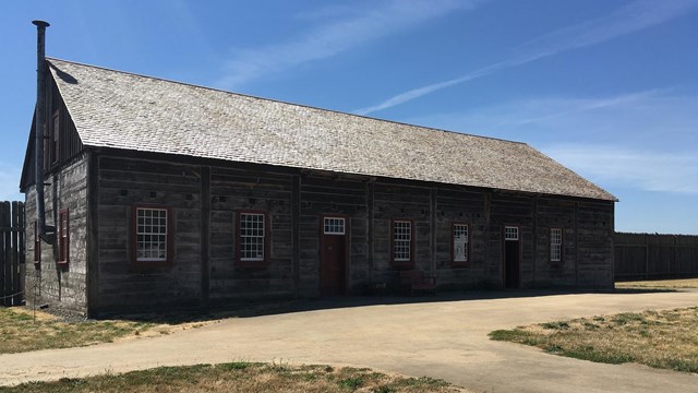A rectangular wooden building with two entrances.
