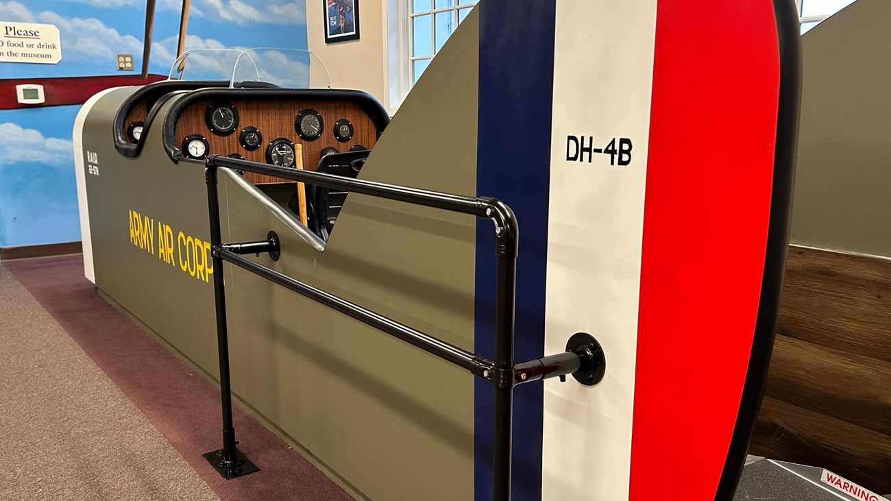 A large replica cockpit of a DH-4 Liberty plane in the Pearson Air Museum lobby.