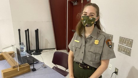 A park ranger inside Pearson Air Museum wearing a cloth face mask.