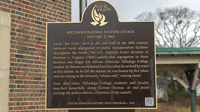 A metal sign with the title "Anniston Civil Rights Trail Trailways Bus Station Attack May 14, 1961."