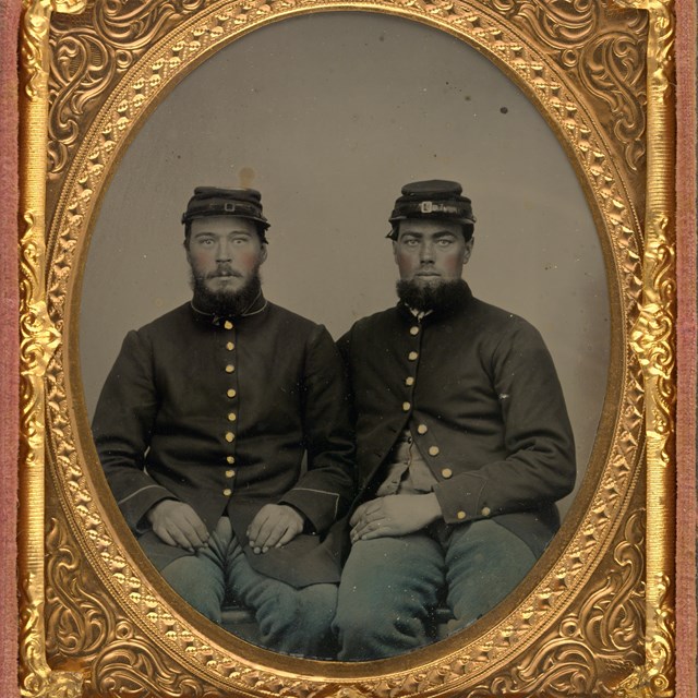 Two Civil War soldiers seated next to one another
