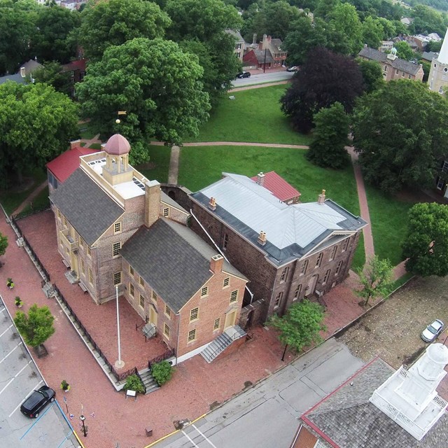 Aerial view of a colonial town with a green park space
