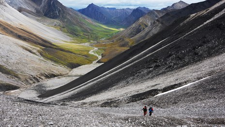 Hikers ascending a rocky slope in the mountains