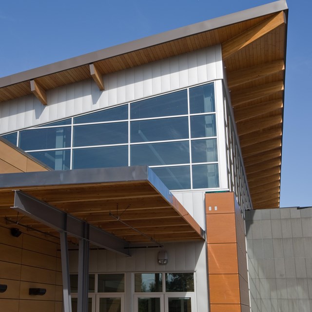 Entrance of the Morris Thompson Center set against a bright blue sky