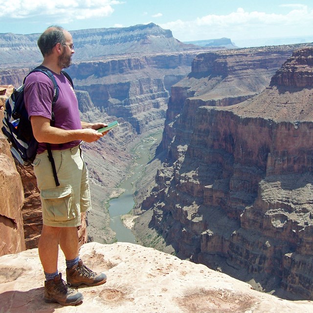 person standing on the rim of the Grand Canyon