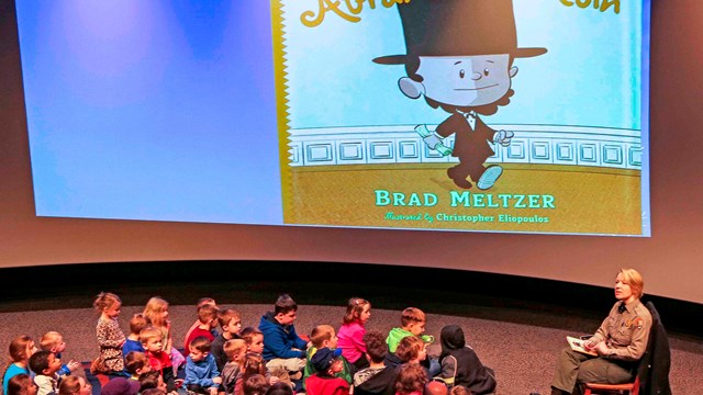 A Park Ranger Reads a Book to a Group of Young Children
