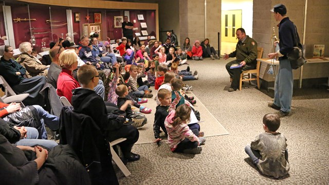 A Park Ranger Reads a Book to a Group of Young Children