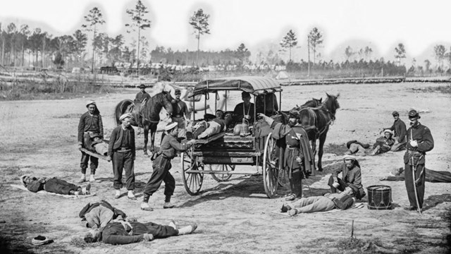Soldiers practice carrying men on stretchers
