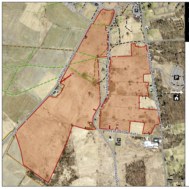 A map showing tan and green for different fields with a red layer over top to mark a project area.