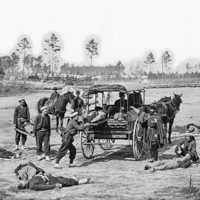 Soldiers load wounded into an civil war ambulance
