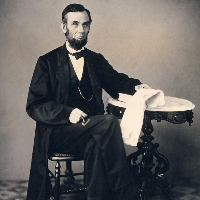 Abraham Lincoln seated at table
