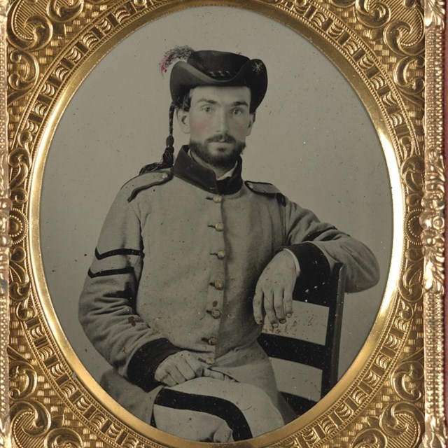 A seated Confederate Soldier
