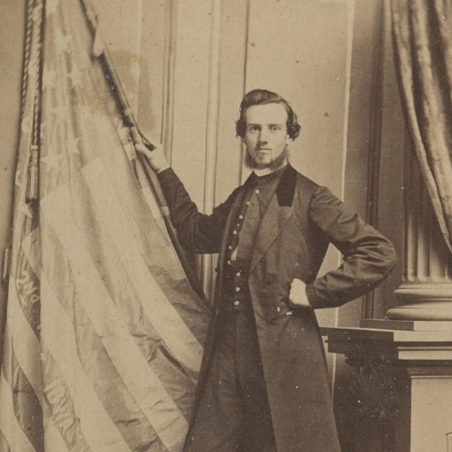 United States Soldier standing with Flag