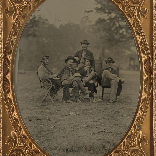 Soldiers seated with food on their laps