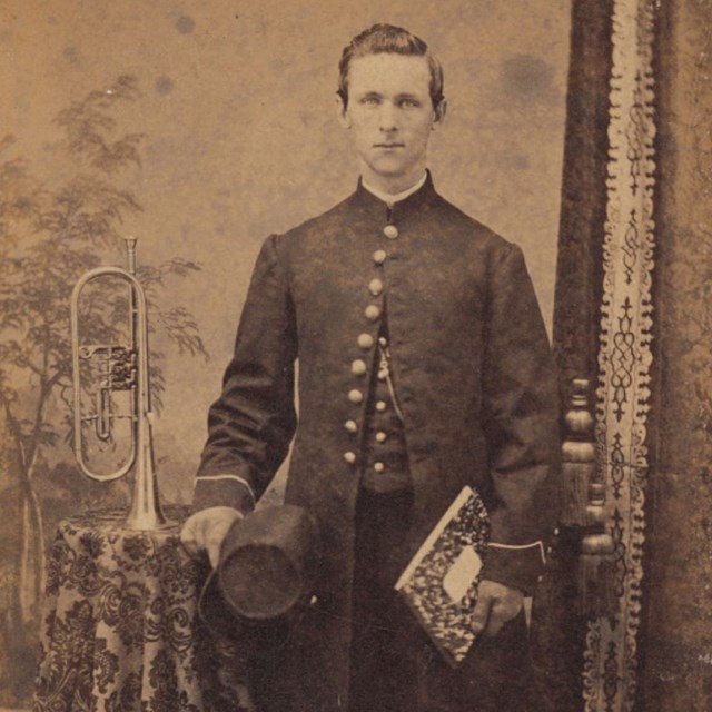 A U.S. Soldier standing next to a musical instrument