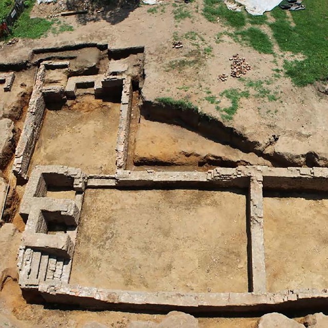 an excavated building foundation deep in the ground.