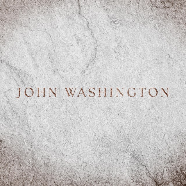 A stone background with the name 