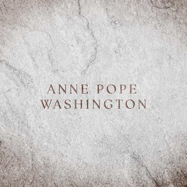 A stone surface with text engraved 