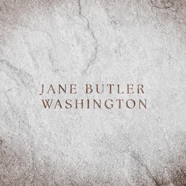 A stone slab with text engraved reads 