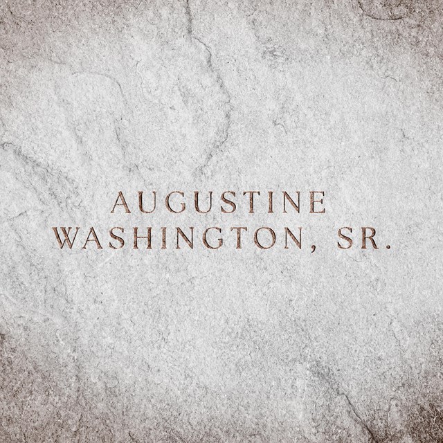 A stone slate with text engraved reads, 