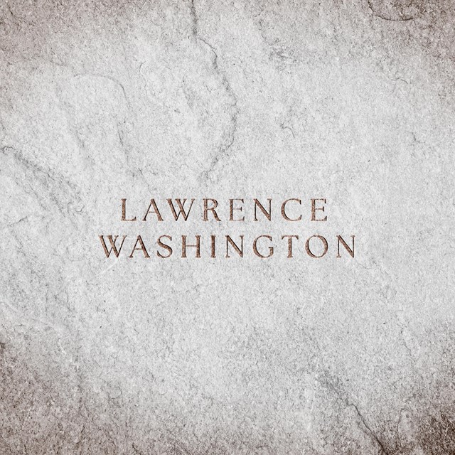 A stone slab with text engraved reads 