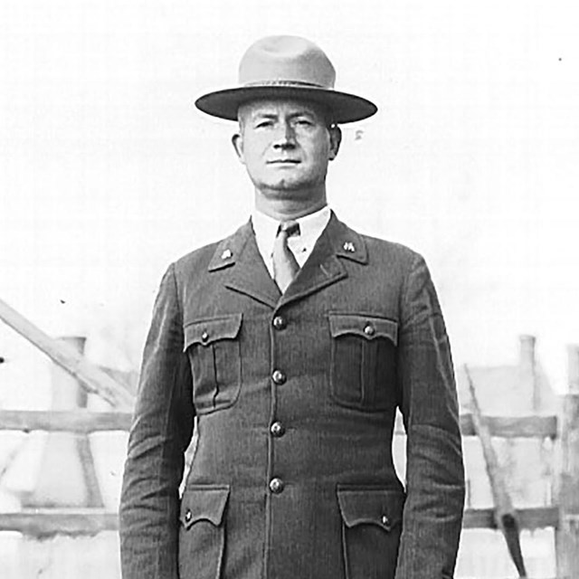 Phillip Hough standing in uniform in front of a gate
