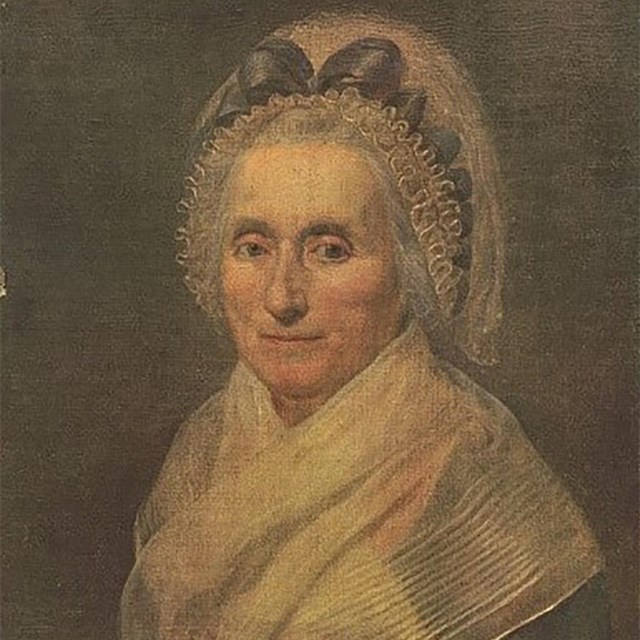 a portrait drawing of an older woman with white hair, wearing a bonnet and colonial attire.