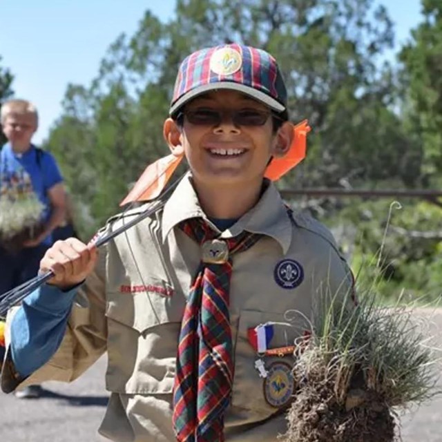 A boy scout smiling while in uniform