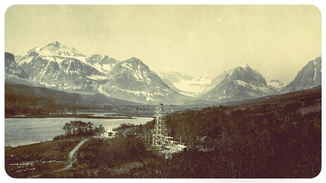 a landscape image with an oil well in the middle