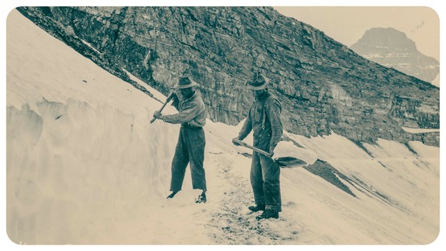 Two people shovel snow on a mountain trail.