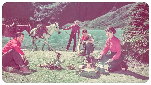 A group of people sitting by a lake.