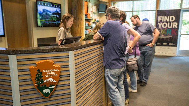 Ranger talking to park visitors at an information desk