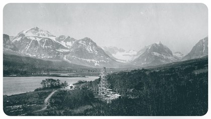 black and white of an oil well in the foreground and Grinnell <a href=