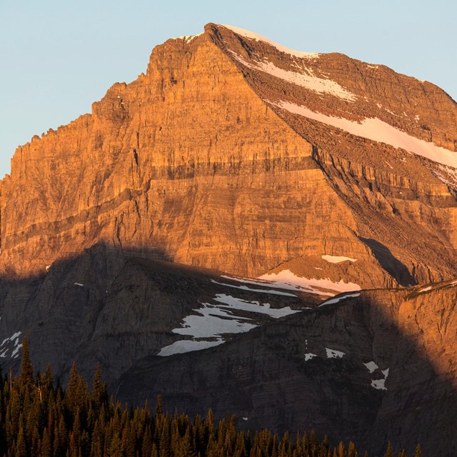 sloping mountain with dark rock band