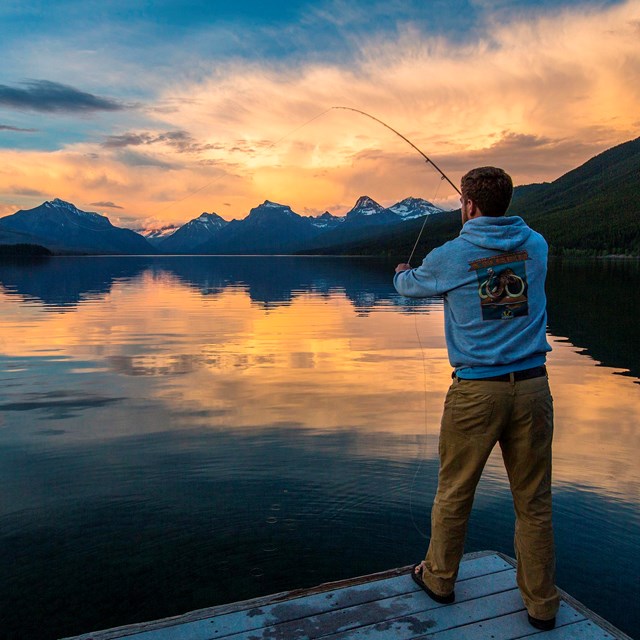 Visitor fly fishing on Lake McDonald during the sunset