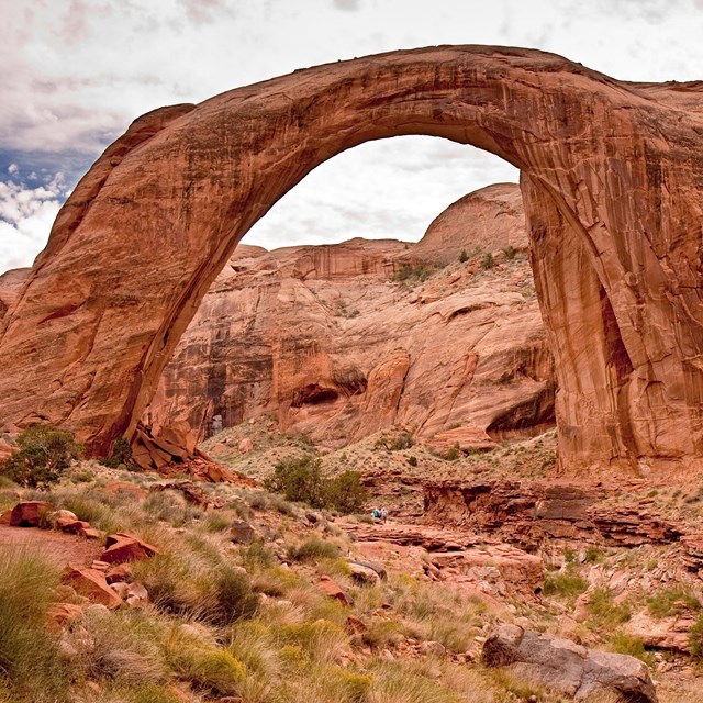 A large natural sandstone arch-shaped bridge.