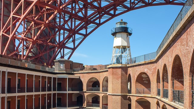 Brick military fort underneath Golden Gate Bridge