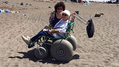 Women sitting in a beach wheelchair. 