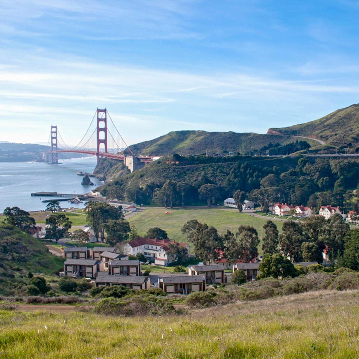 Buildings of Fort Baker nestled in the hills of the foreground, Golden Gate bridge & SF Bay behind