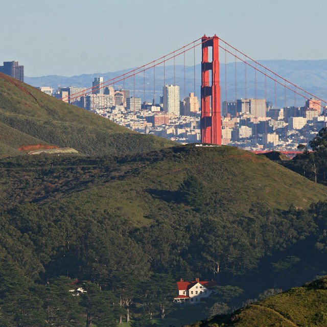 Fort Barry nestled in green hills with Golden Gate Bridge and San Francisco behind