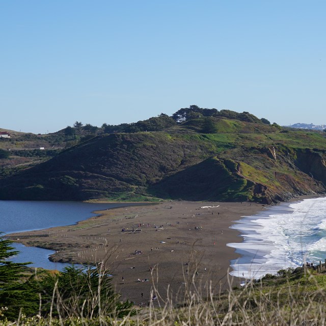 View of Rodeo Beach, bordered by the Pacific Ocean on one side and Rodeo Lagoon on the other side. 
