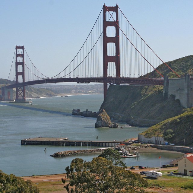 View across Horseshoe Cove with Golden Gate Bridge behind 